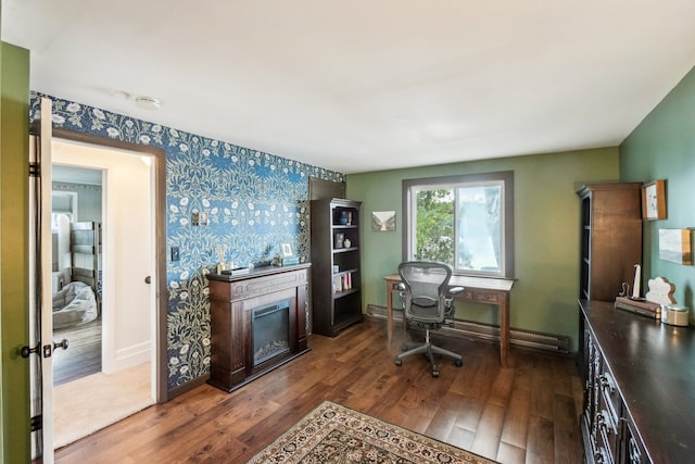 home office with a baseboard radiator and dark wood-type flooring