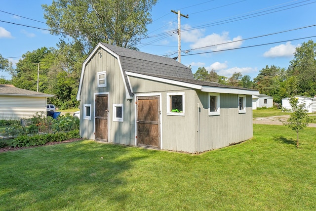 view of outbuilding with a yard