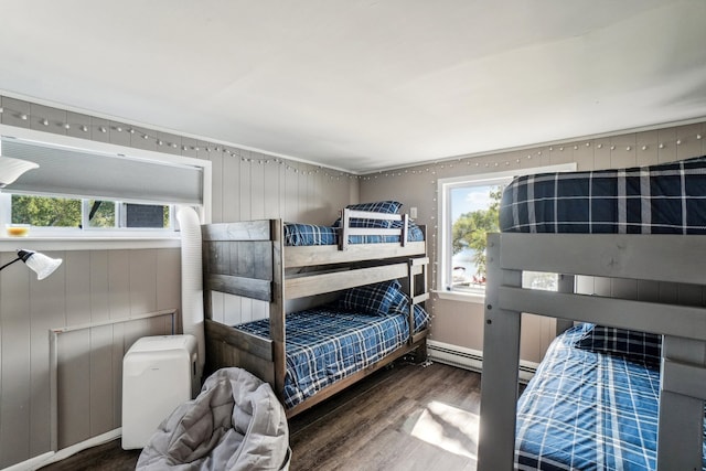 bedroom with dark hardwood / wood-style floors and wood walls