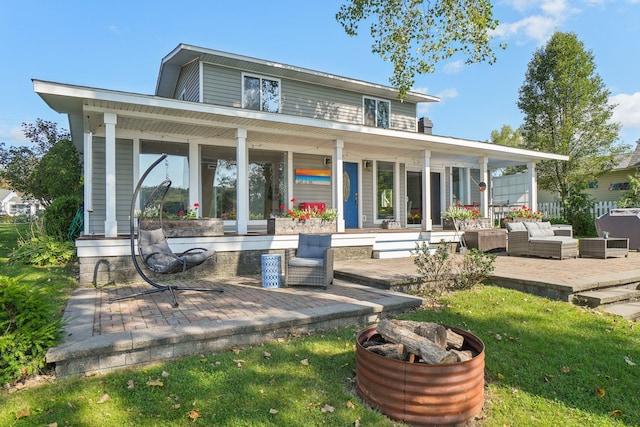 back of property featuring outdoor lounge area and a patio area