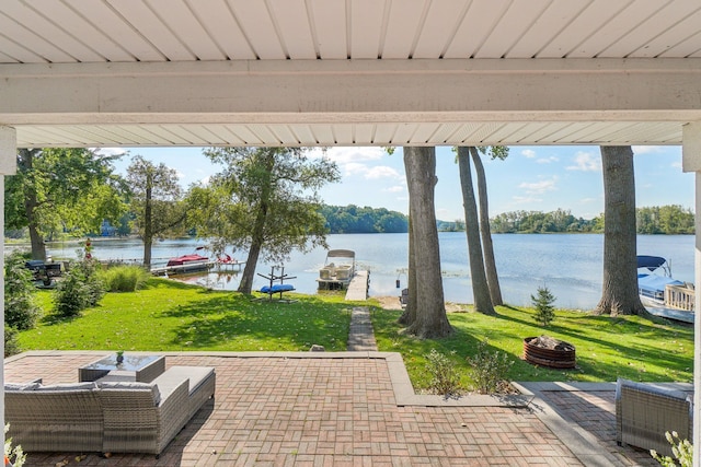 view of patio / terrace with a fire pit and a water view