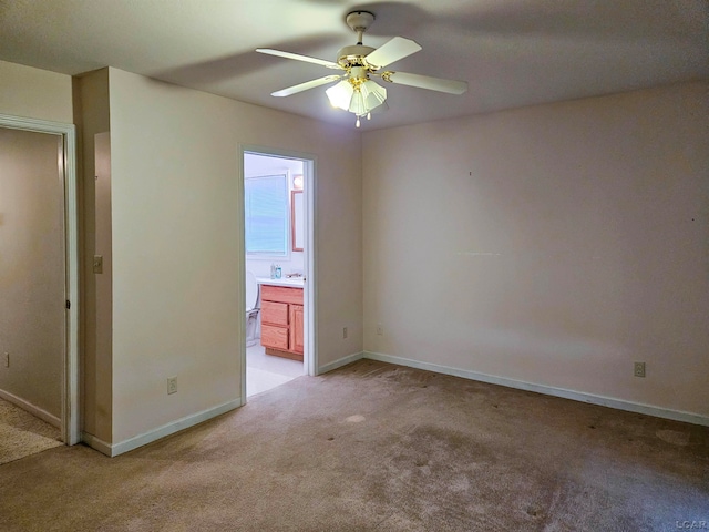 spare room with ceiling fan and light carpet