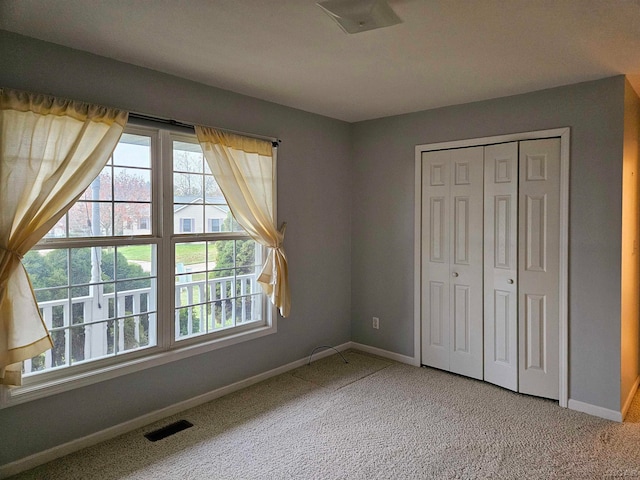 unfurnished bedroom with carpet flooring and a closet