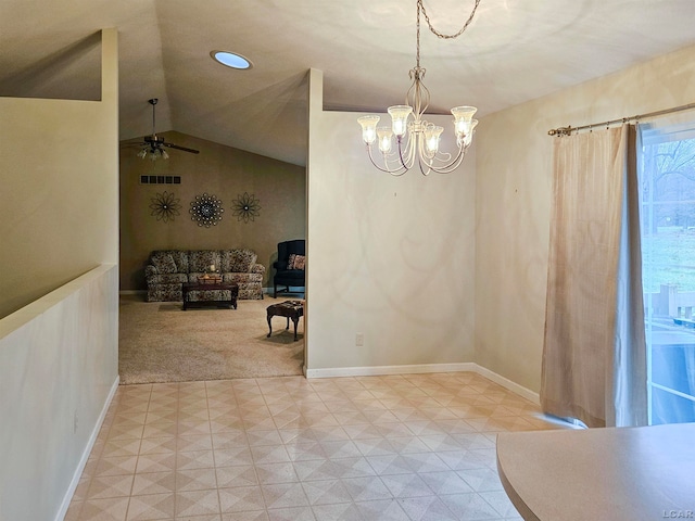 carpeted dining area with ceiling fan with notable chandelier and vaulted ceiling