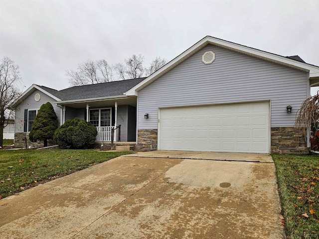 ranch-style home featuring covered porch, a garage, and a front yard