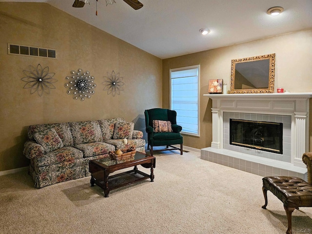 living room featuring carpet flooring, a fireplace, lofted ceiling, and ceiling fan