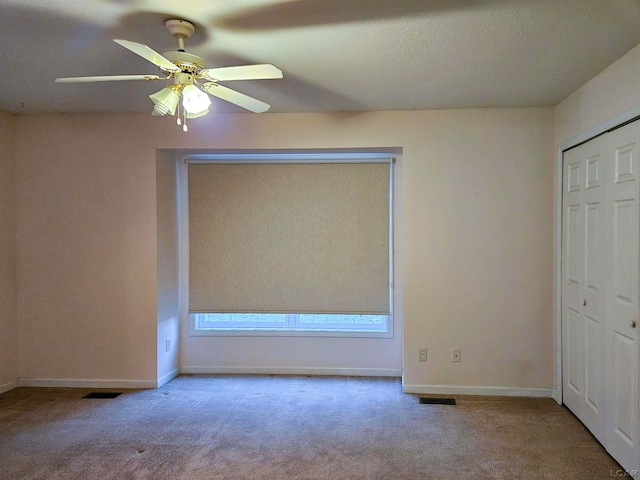 unfurnished bedroom with ceiling fan and carpet