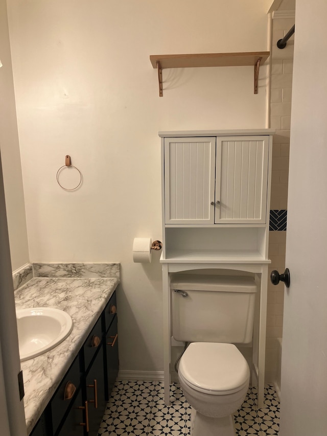 bathroom featuring tile patterned flooring, vanity, and toilet