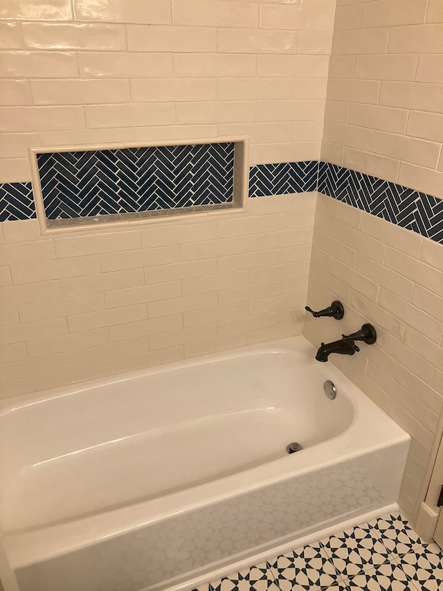 bathroom featuring tile patterned flooring and a washtub