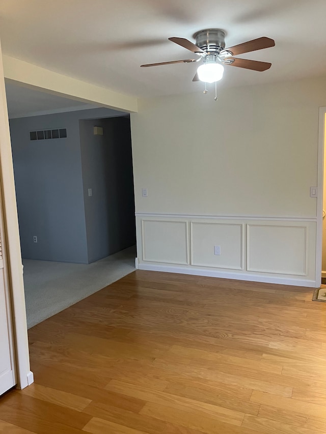 unfurnished room featuring ceiling fan, light hardwood / wood-style floors, and ornamental molding