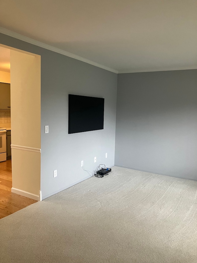 unfurnished living room with crown molding and light wood-type flooring