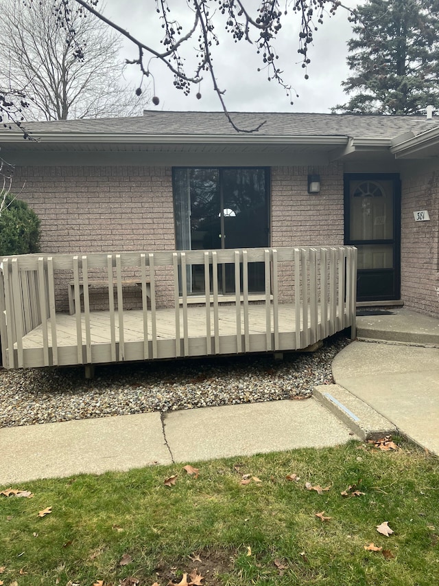 rear view of property featuring a deck