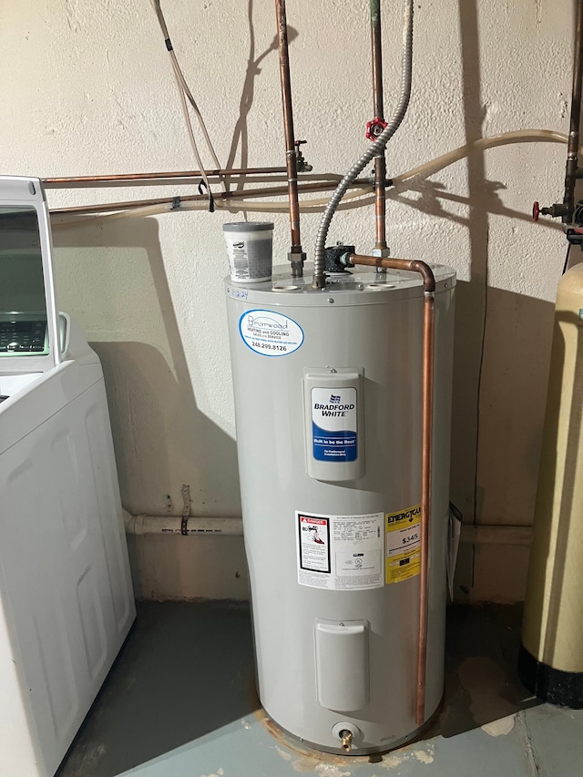 utility room featuring washer / dryer and electric water heater