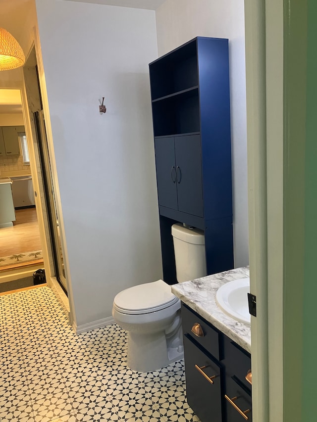 bathroom featuring tile patterned floors, vanity, toilet, and backsplash