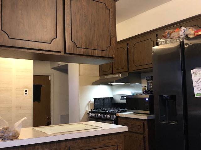 29161 Schoenherr Rd, Warren, MI 48088 - kitchen with stainless steel appliances, under cabinet range hood, light countertops, and dark brown cabinets