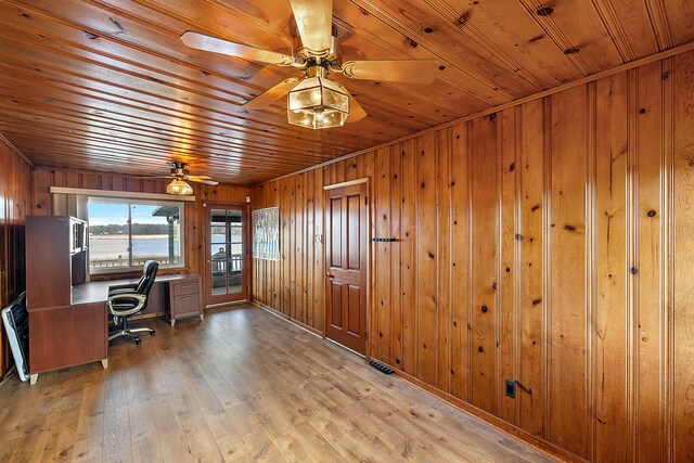 unfurnished office with ceiling fan, light hardwood / wood-style floors, wooden ceiling, and wooden walls