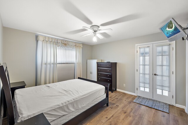 bedroom with wood-type flooring, access to outside, and ceiling fan