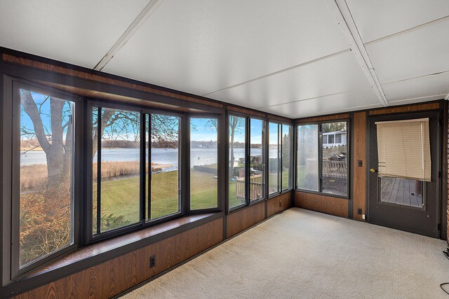 sunroom / solarium with a water view