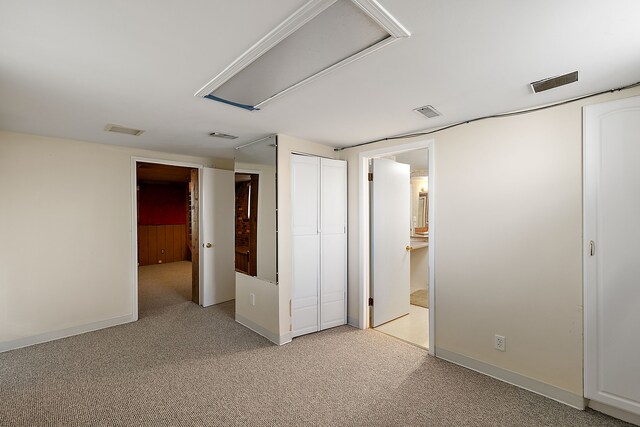 unfurnished bedroom featuring light carpet, baseboards, and visible vents