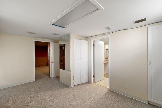 basement with light colored carpet, baseboards, and visible vents