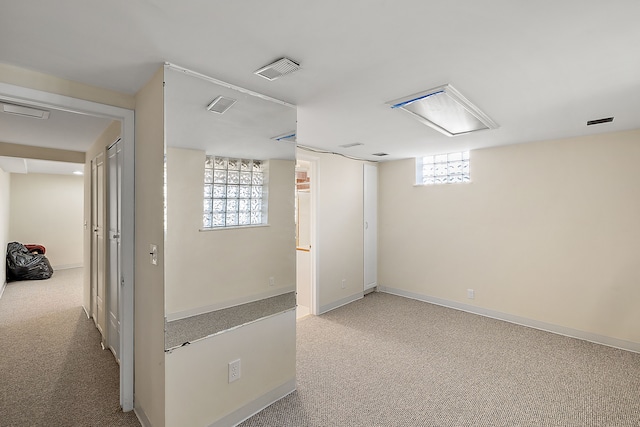 below grade area with plenty of natural light, visible vents, and carpet floors