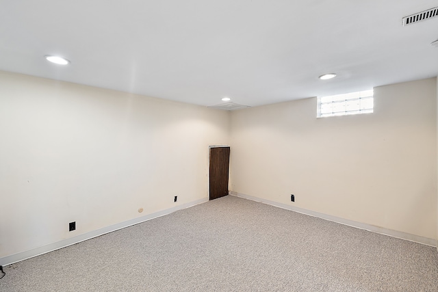 basement with visible vents, baseboards, recessed lighting, and light colored carpet