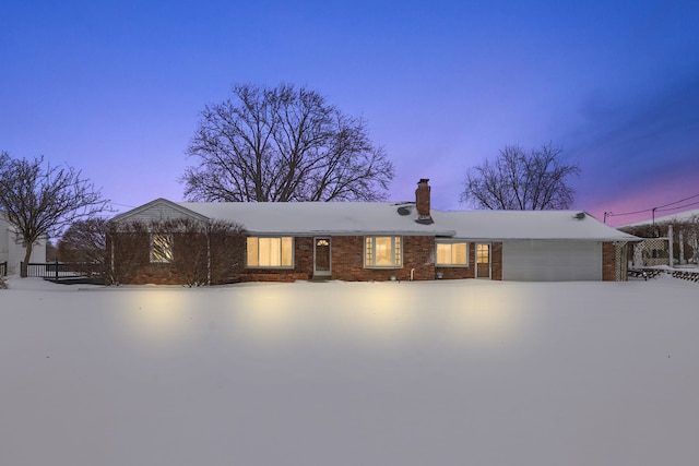 single story home featuring a garage, brick siding, and a chimney