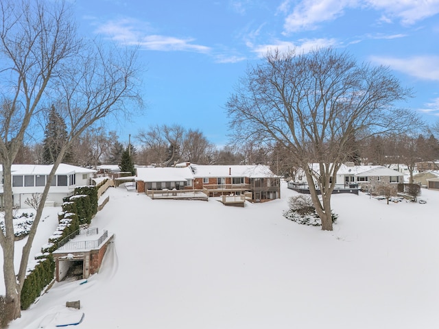 snowy aerial view with a residential view