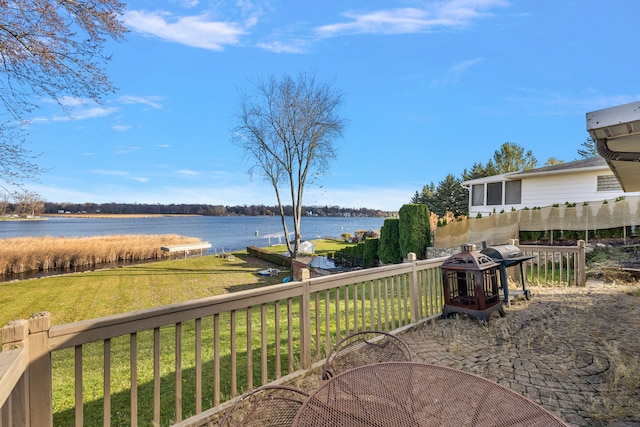 exterior space with a water view and a lawn