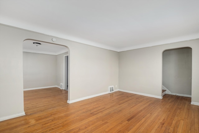 empty room with light hardwood / wood-style flooring