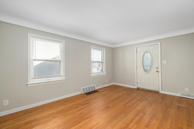 foyer entrance with light hardwood / wood-style floors