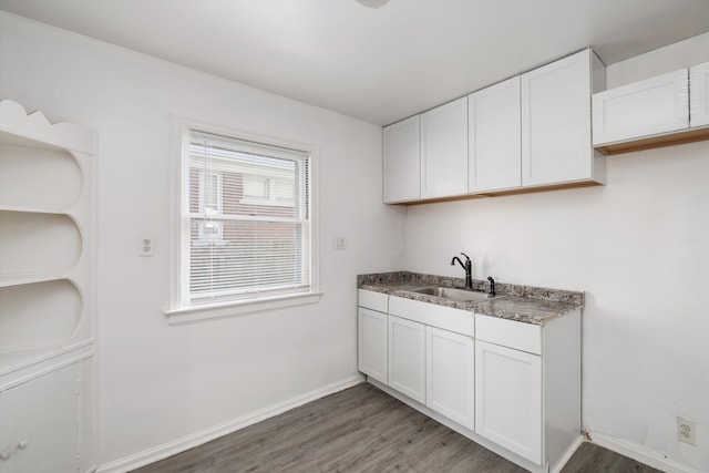 kitchen featuring dark hardwood / wood-style floors, white cabinetry, and sink