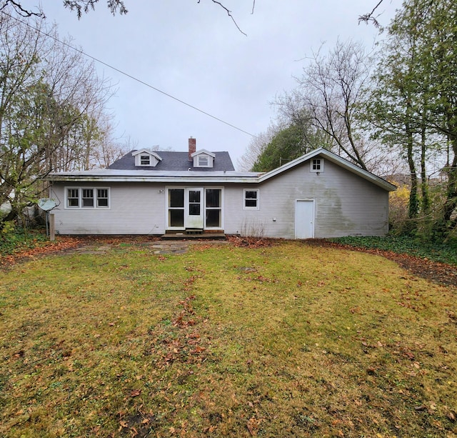 rear view of house with a lawn