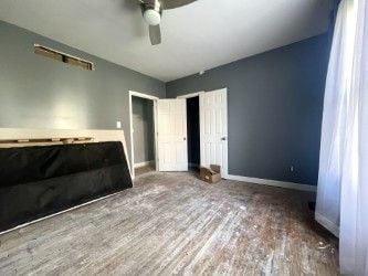 unfurnished bedroom featuring hardwood / wood-style flooring and ceiling fan