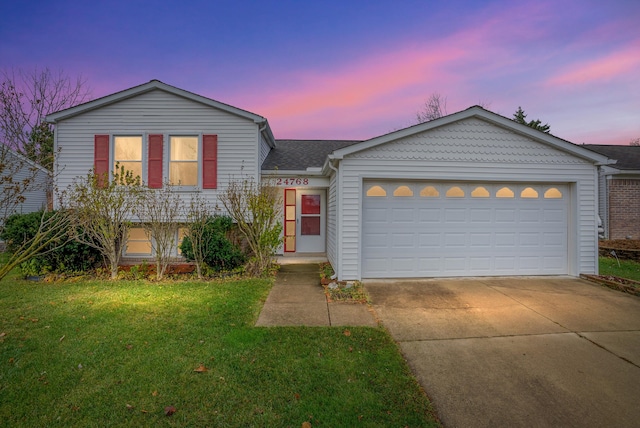 view of front facade with a garage and a yard