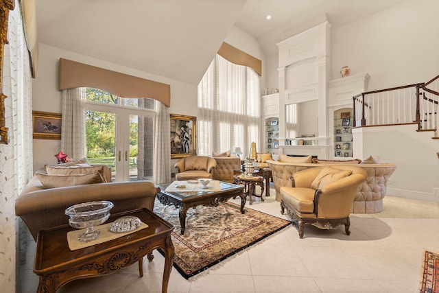 living area with light tile patterned floors, high vaulted ceiling, and french doors