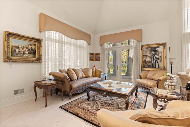 living area with light tile patterned floors and high vaulted ceiling