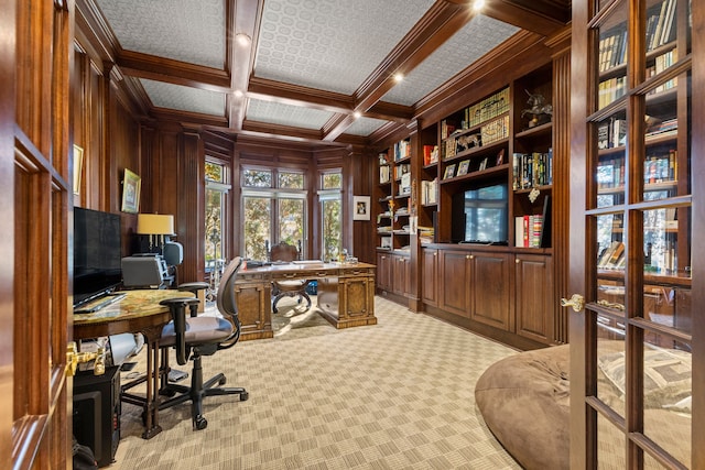 carpeted office space featuring coffered ceiling, crown molding, wooden walls, built in features, and beamed ceiling