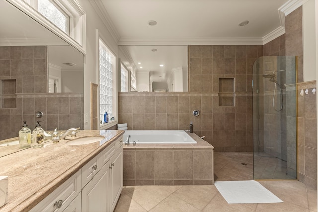 bathroom with vanity, tile patterned floors, crown molding, shower with separate bathtub, and tile walls