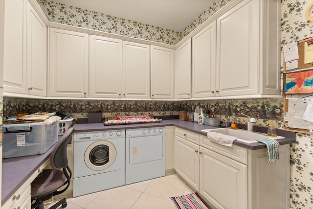 washroom with cabinets, sink, washer and clothes dryer, and light tile patterned flooring