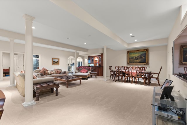 carpeted living room featuring decorative columns