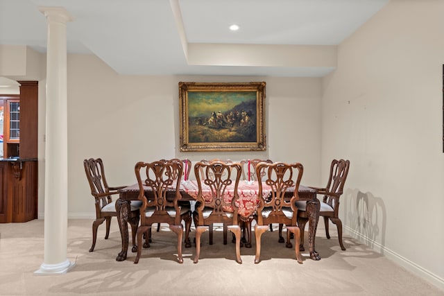 carpeted dining room with ornate columns