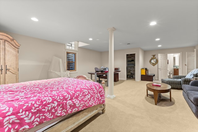 bedroom featuring a spacious closet and light colored carpet