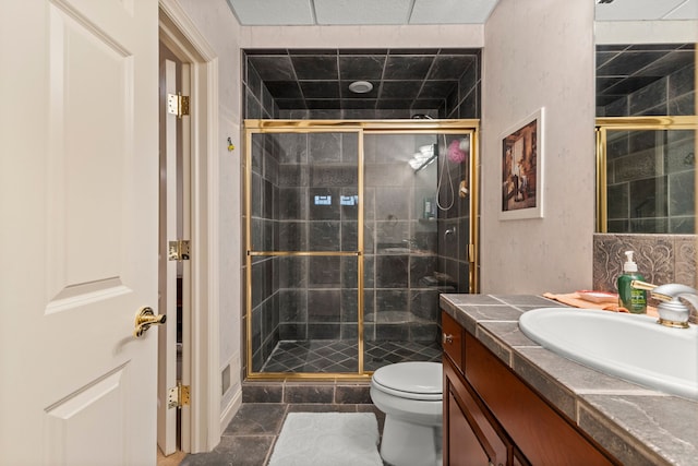 bathroom with tile patterned floors, toilet, an enclosed shower, and vanity