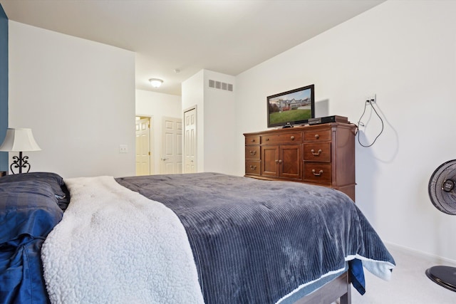 bedroom with baseboards, a closet, visible vents, and carpet flooring