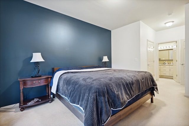 carpeted bedroom with ensuite bathroom