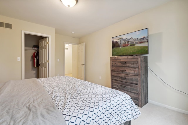 carpeted bedroom featuring visible vents and baseboards