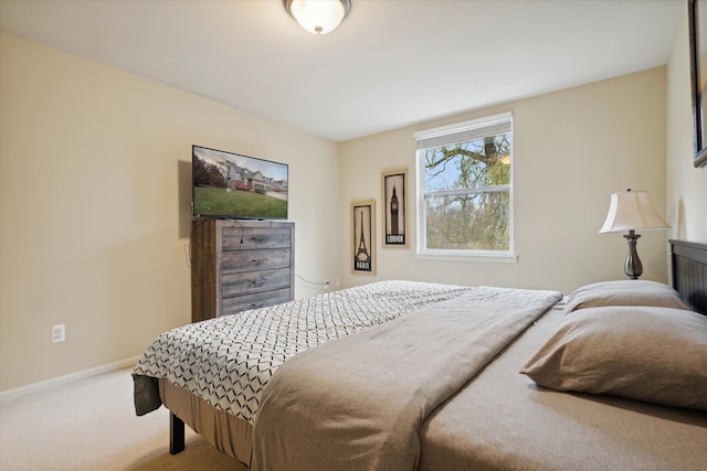 carpeted bedroom featuring baseboards