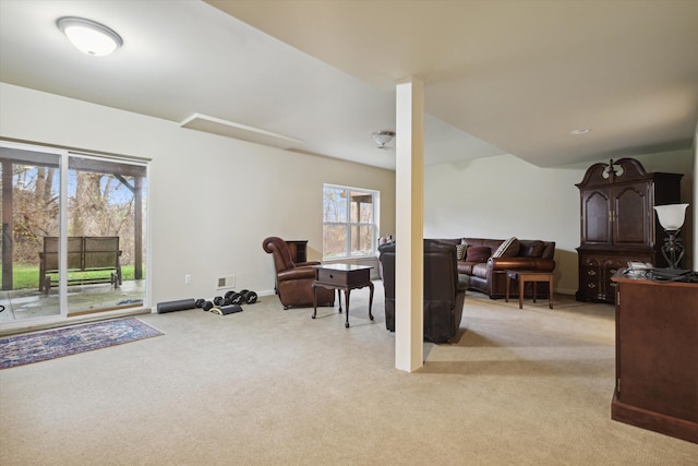 living area featuring light carpet, baseboards, and visible vents