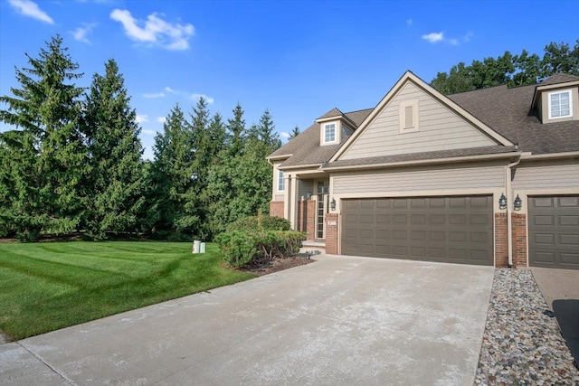 view of front of home with an attached garage, concrete driveway, brick siding, and a front yard